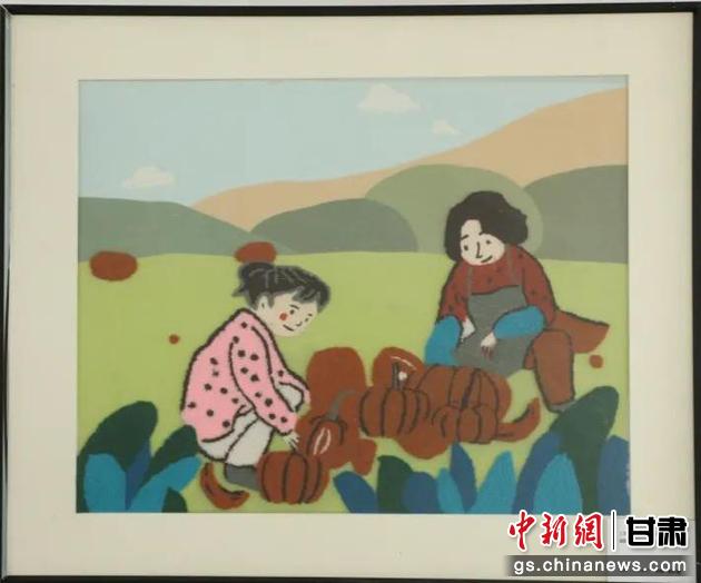 嘉峪關(guān)市新城鎮(zhèn)新城村農(nóng)業(yè)產(chǎn)業(yè)園區(qū)內(nèi)，母女兩人在摘南瓜。刺繡 馬艾米乃 繡稿 敬紅霞